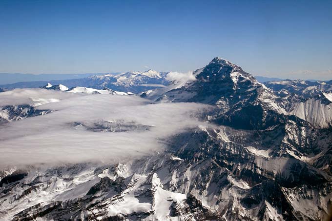 Mt Aconcagua is the highest mountain in the world outside of Asia. Located in Argentina, South America, it reaches an impressive height of 6962 metres (22841 feet). This photo shows the beautiful mountain peak reaching through the clouds.