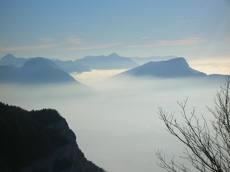 High in the mountains a photographer takes a spectacular image of mountain clouds at what seems like the top of the world.